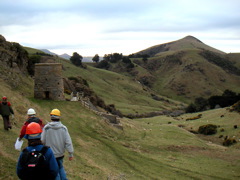 Here we're walking to another site to find rocks.  The brick structure is an old furnace for making concrete.  The little beige specks in the valley are sheep.  The girl closest to the camera lives next to my flat, which I only know because of her hat.  And no, I do not mean the orange hat, I mean the blue hat underneath.  And yes, I too wear the same hat all the time.  We were all freezing our asses off by this time, but it's all good.
