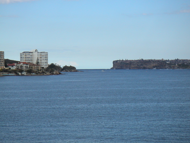 We bought an all-day travel pass and took the ferry across the harbour to "Manly" where we laughed at the "manly cafe" and "manly laundromat" and "manly festival" and such.  Here is a glipse of ocean from inside the harbour.