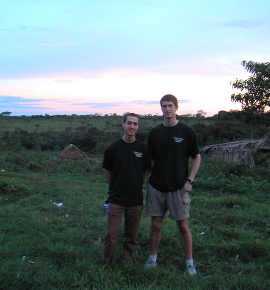 Robin and Karl are wearing the same choir shirt as the sun sets.