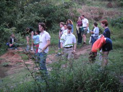 Choir folk down by the river.  Katie stretches.