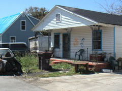 Every house had been marked with a big X and information about the party who had "inspected" it.  There is a date at the top, the number of bodies found is at the bottom, and initials of the search group are at the left.  Some houses had "TFW" which meant "toxic flood waters".  We operated under the assumption that all houses had been flooded with toxic water, since after all it was the same water everywhere.