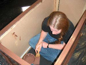 Grace sits in a box.